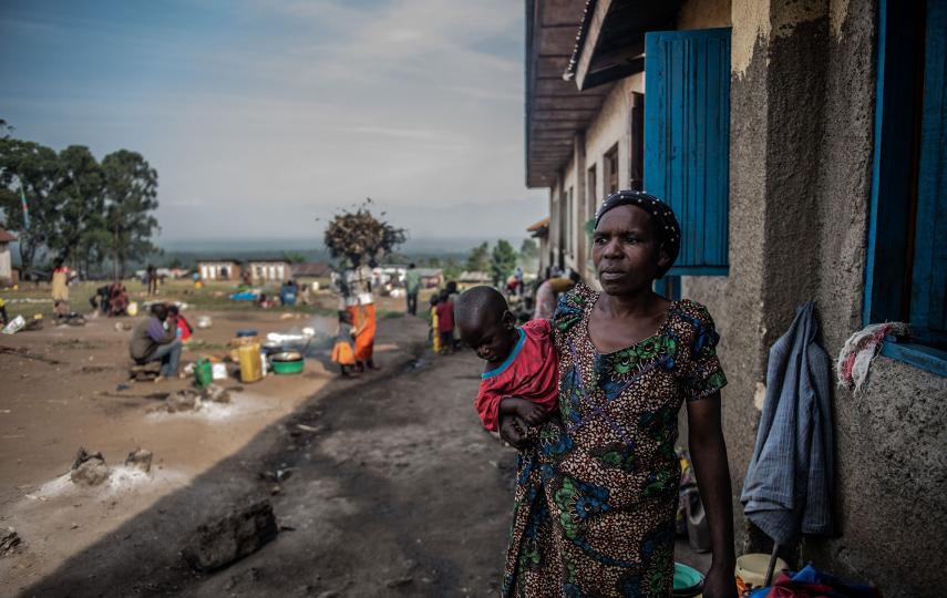 A displaced woman looks after a child at a primary school in Rutshuru town, in eastern DRC. An insurgency by the M23 rebel group has uprooted 170,000 people since March.
