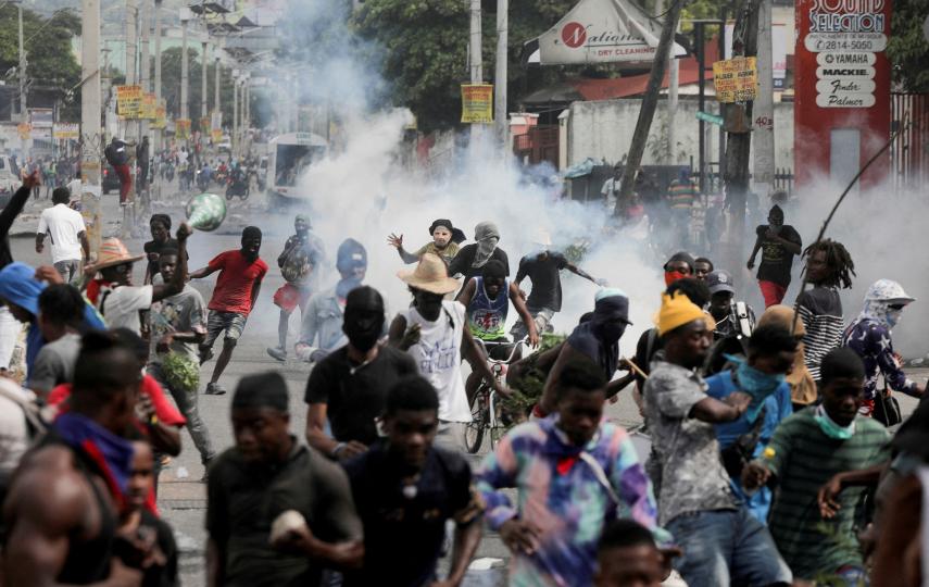 Gangs have exploited the security vacuum since the July 2021 assassination of President Jovenel Moïse. Police fire tear gas at protesters demanding the resignation of interim PM Ariel Henry after weeks of shortages in Port-au-Prince, in October 2022.