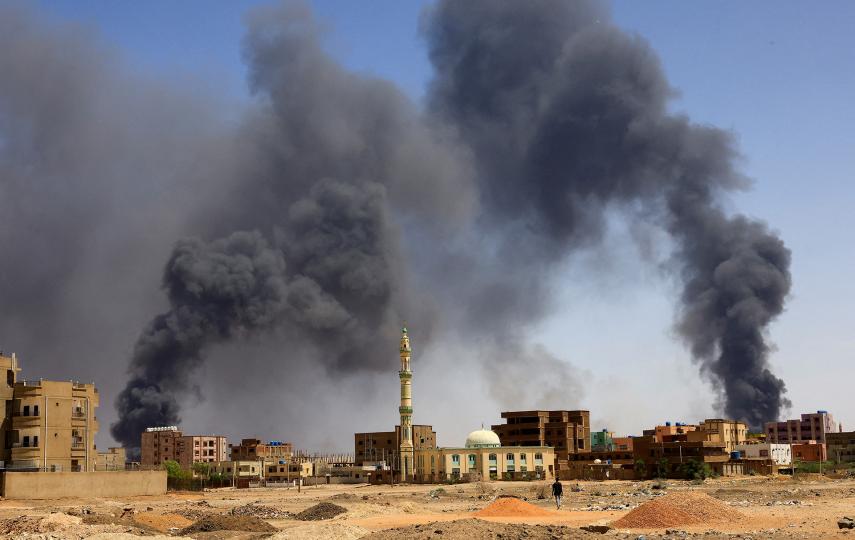 A photo of dark smoke plumes rising over Khartoum