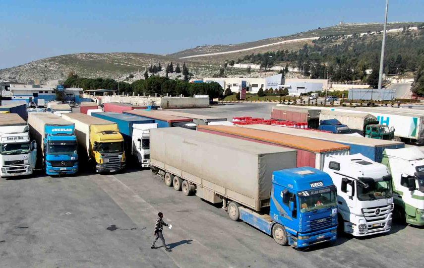 Trucks carrying aid from UN World Food Programme (WFP), following a deadly earthquake, are parked at Bab al-Hawa crossing, Syria February 20, 2023.